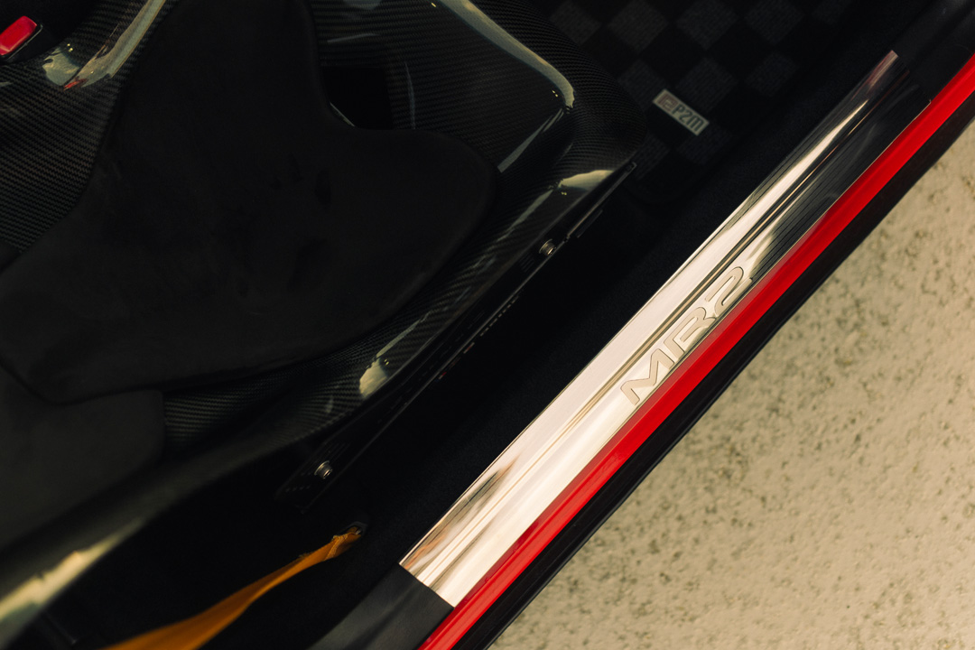 Toyota MR2 door sill detail with brushed metal trim and carbon fiber interior accents