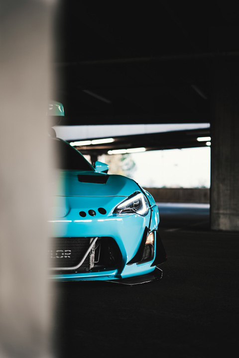 Nicholas Sargeant’s widebody 2016 Scion FR-S parked inside a dimly lit parking garage.