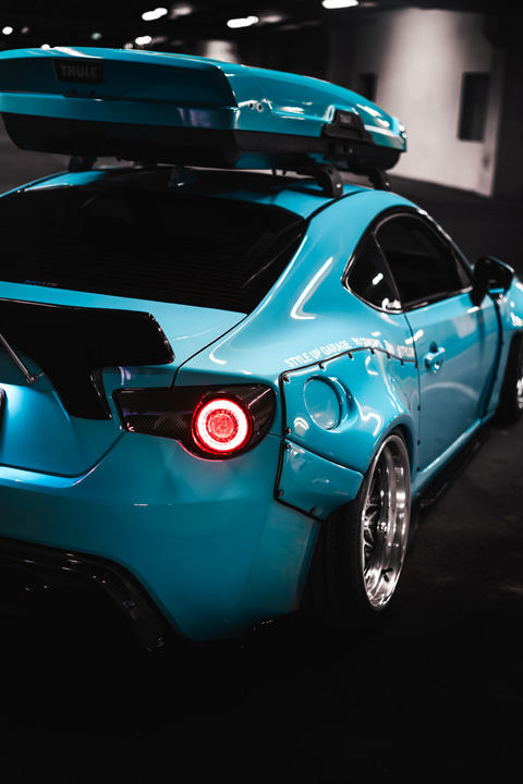 Nicholas Sargeant’s turbocharged Scion FR-S parked in a dark garage with custom widebody styling.