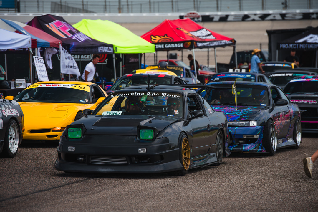 FuelFest attendees walking through the Texas Motor Speedway infield during the Dallas-Fort Worth event.