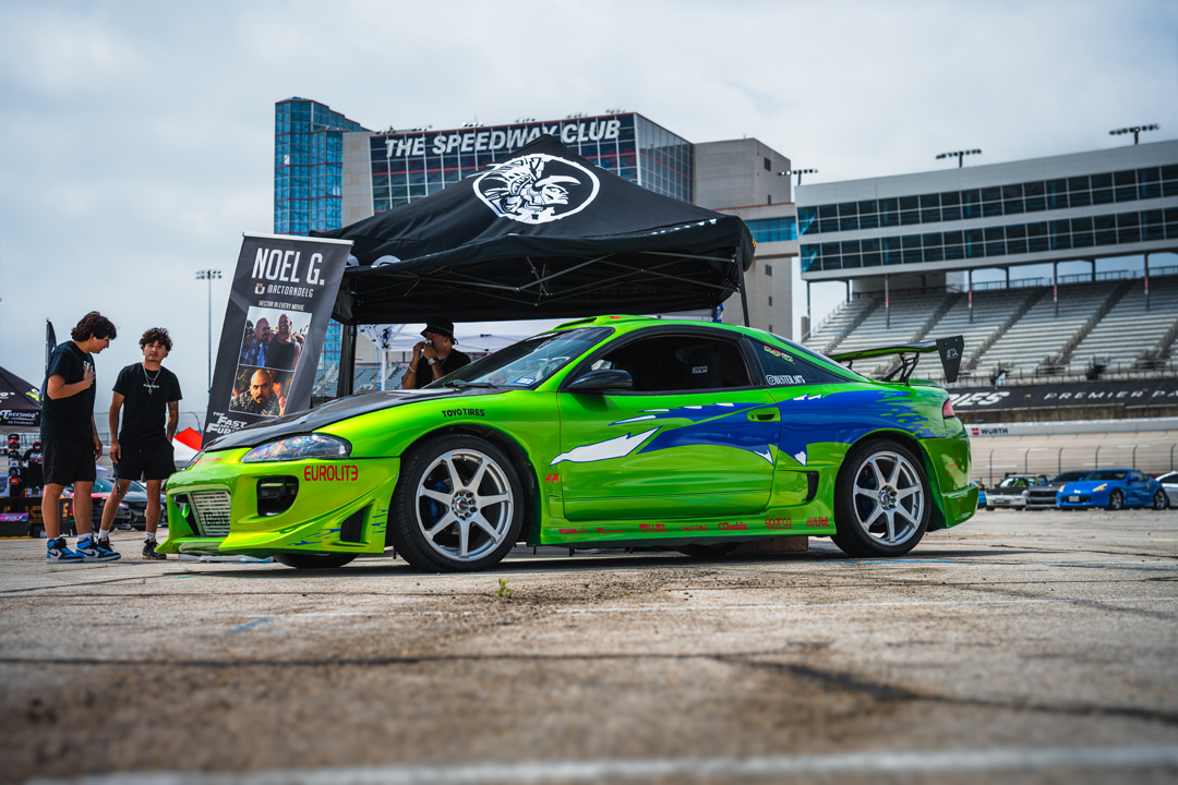 Mitsubishi Eclipse with a bright green Fast & Furious-inspired livery displayed during FuelFest Dallas-Fort Worth at Texas Motor Speedway.