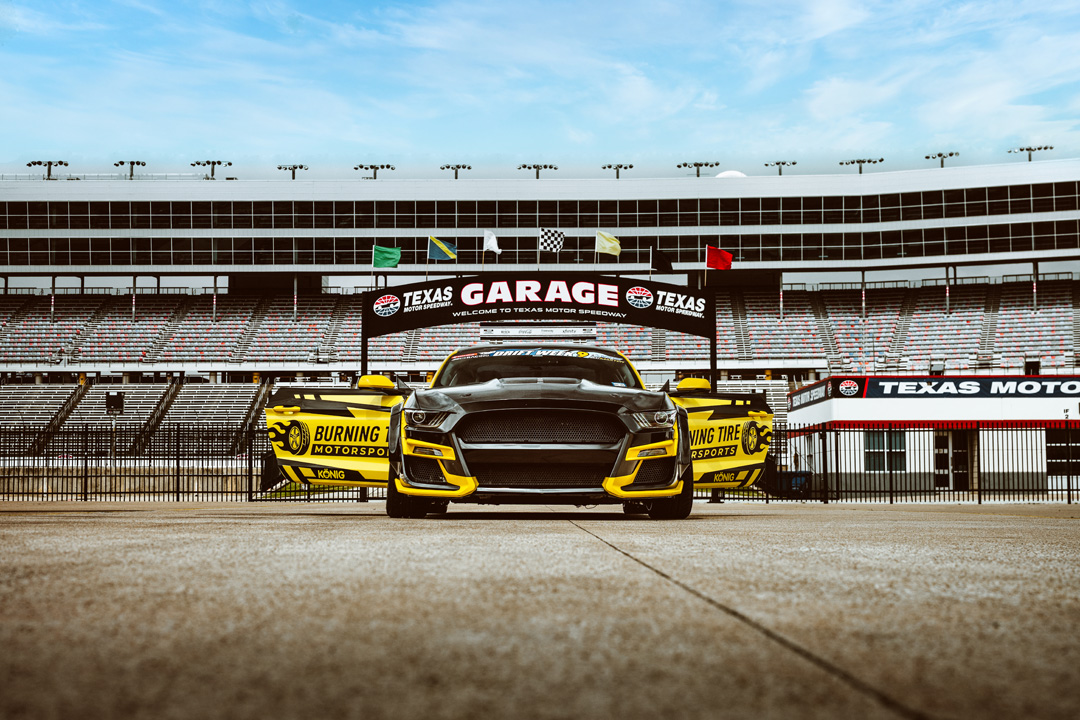 Widebody Ford Mustang drift car displayed inside Texas Motor Speedway during FuelFest Dallas-Fort Worth.