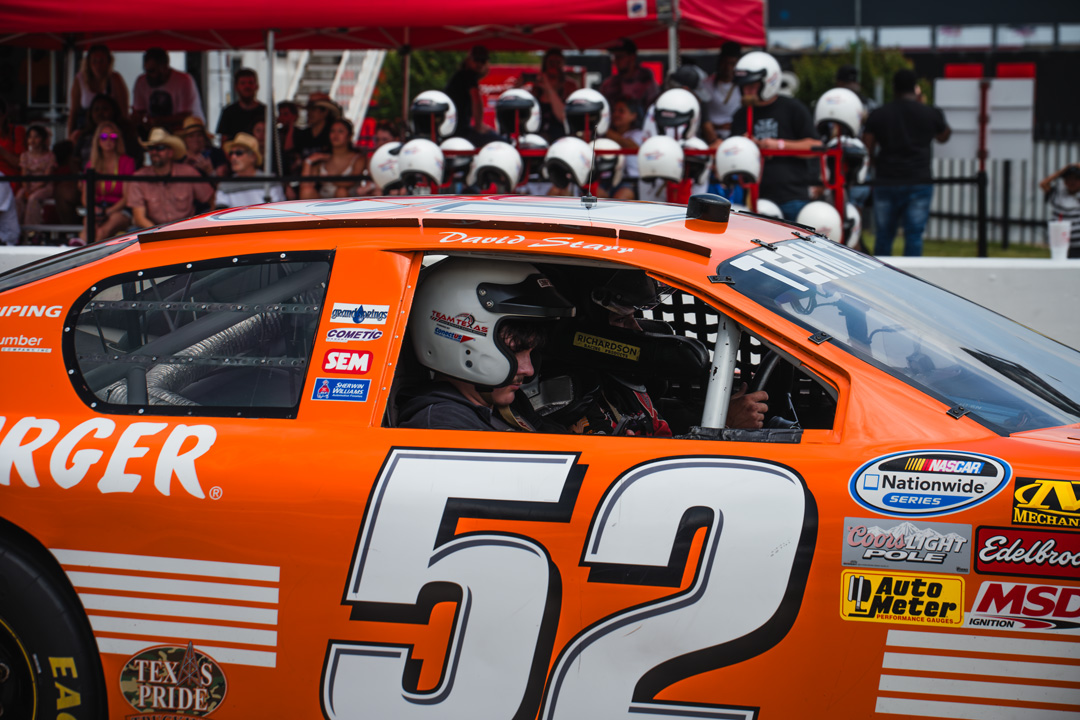 Attendees strapped into a stock car ride-along experience during FuelFest Dallas-Fort Worth at Texas Motor Speedway.