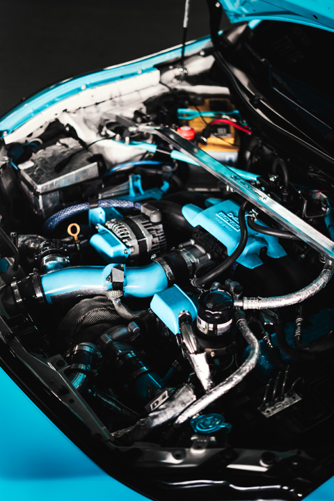 Turbocharged FA20 engine bay inside Nicholas Sargeant’s 2016 Scion FR-S featuring custom blue engine accents and aftermarket cooling upgrades.