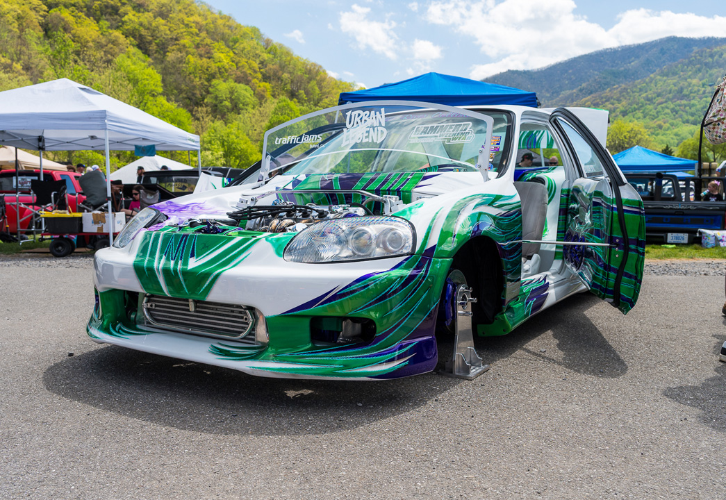 Wild custom Honda Civic show build with green and purple graphics displayed at Mini Truckin’ Nationals.