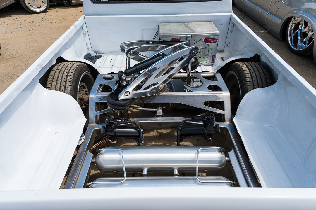 Detailed cantilever air suspension setup installed in the bed of a custom mini truck at Mini Truckin’ Nationals.