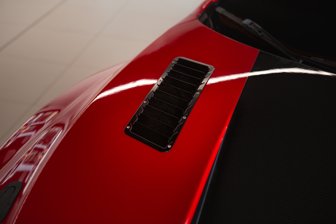 Jon Erickson’s red LS-swapped 2011 Subaru STi with widebody aero and track-focused details.