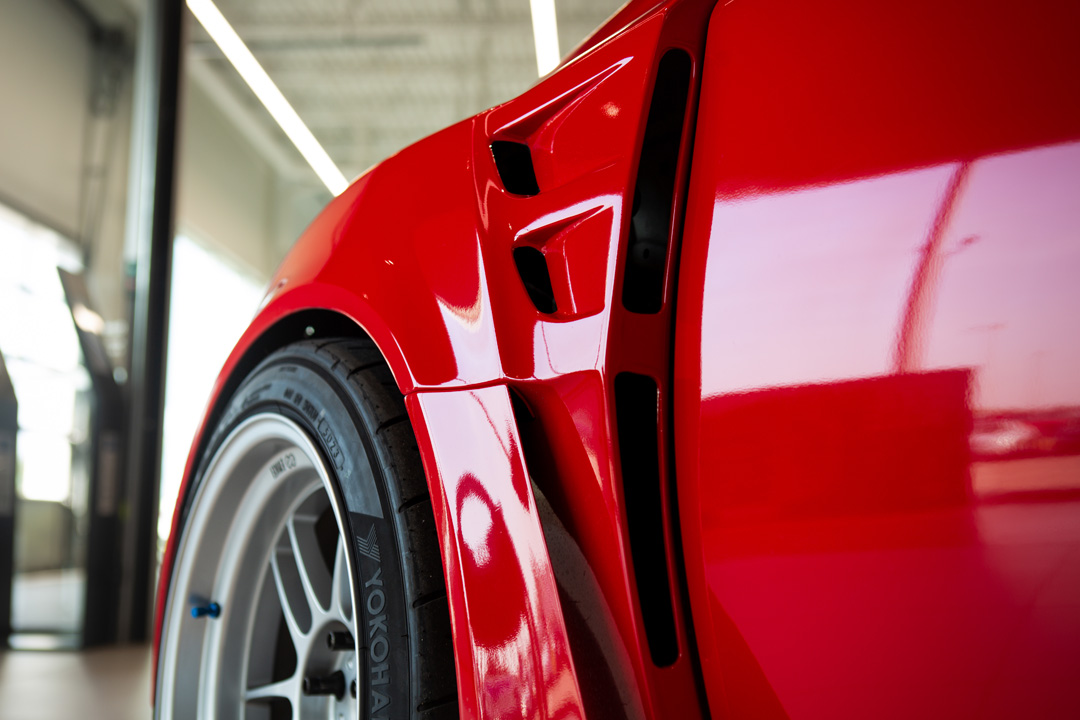 Jon Erickson’s red LS-swapped 2011 Subaru STi with widebody aero and track-focused details.