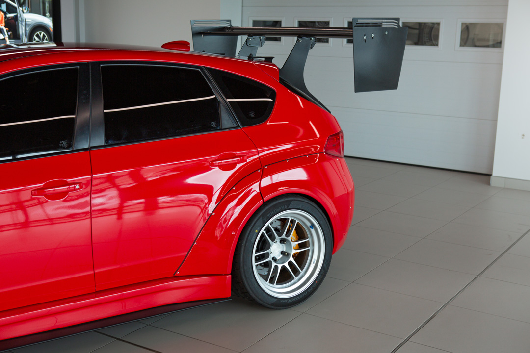 Jon Erickson’s red LS-swapped 2011 Subaru STi with widebody aero and track-focused details.