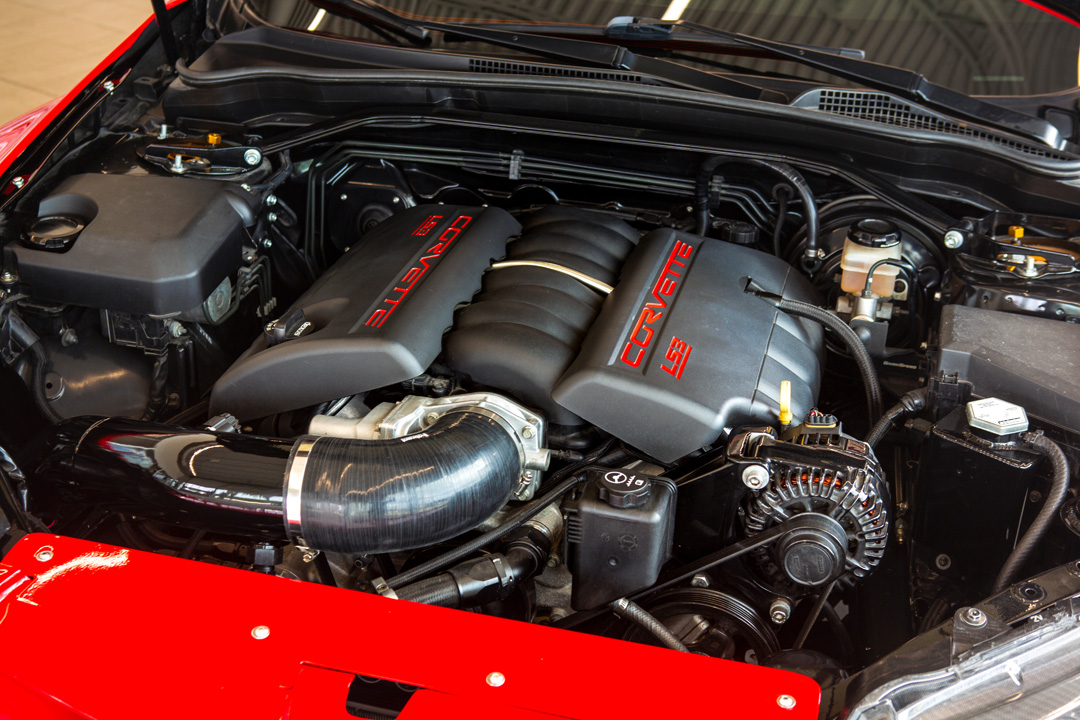 Close-up of Jon Erickson’s 2011 Subaru STi engine bay showing the LS3 Corvette crate motor and custom intake setup.