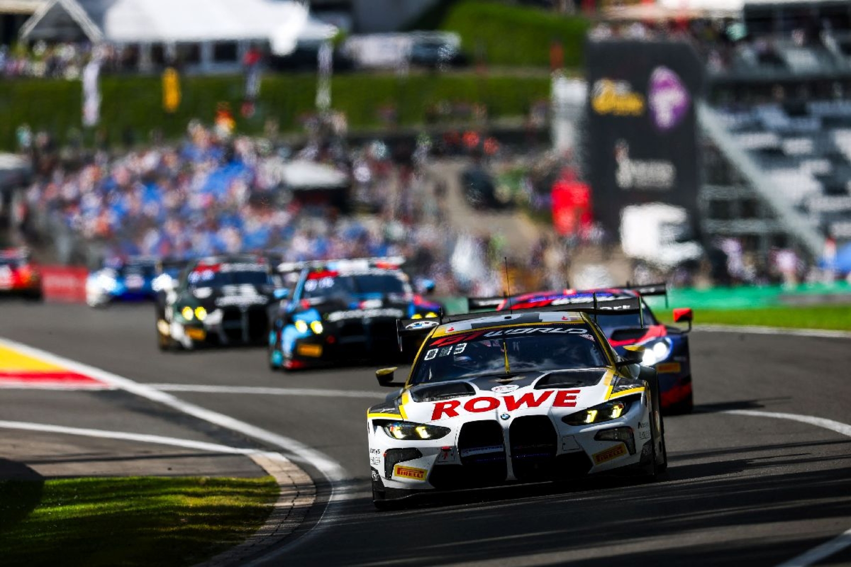 BMW M4 GT3 race car leading a pack of GT3 competitors at the CrowdStrike 24 Hours of Spa.
