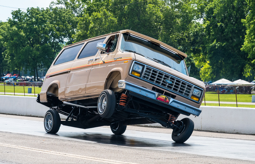 Custom Ford van rides on three wheels during Slamology 2026 at Edgewater Sports Park in Cleves, Ohio.