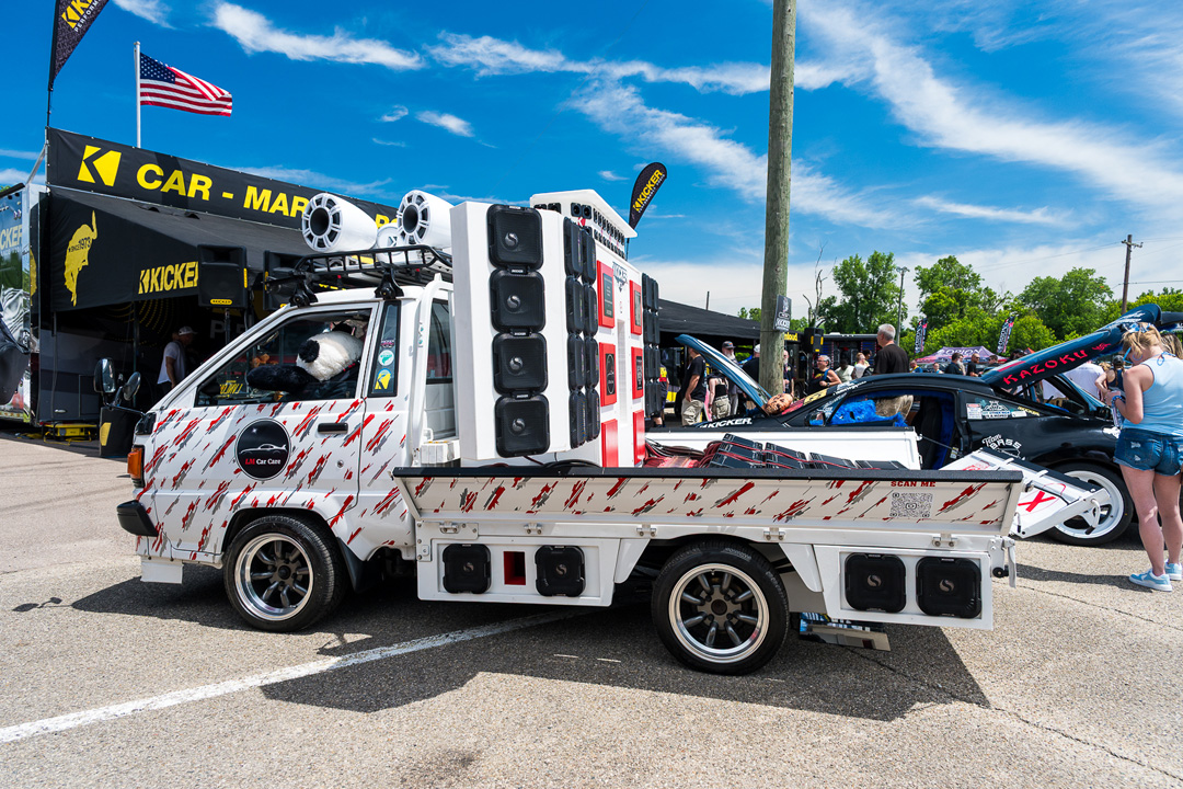 Custom mini truck audio build displayed near the KICKER vendor area at Slamology 2026 at Edgewater Sports Park.