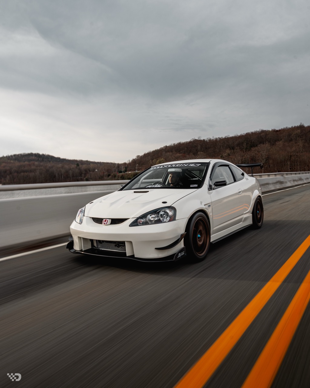 Moises Wynns’ Championship White 2003 Acura RSX with J’s Racing aero, right-hand-drive conversion, Mugen MF10 wheels, Toyo R888R tires, K-series power, and DC5 Type R details.