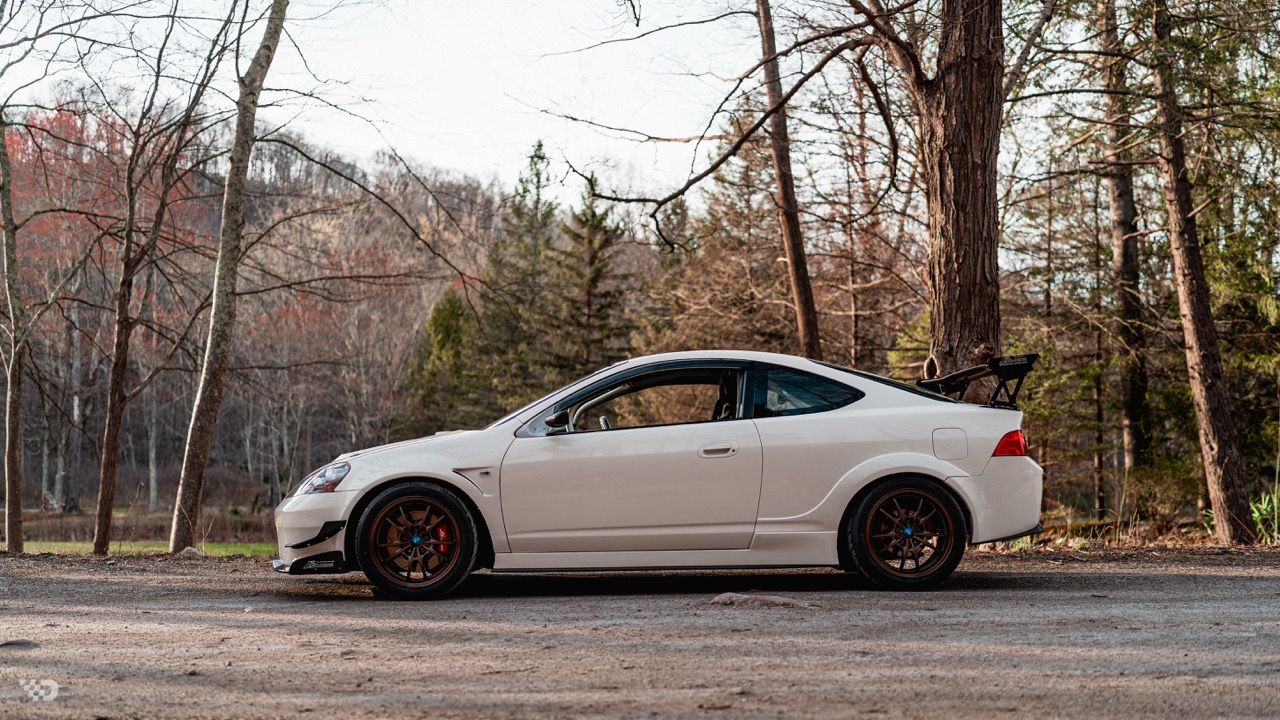 Moises Wynns’ Championship White 2003 Acura RSX with J’s Racing aero, right-hand-drive conversion, Mugen MF10 wheels, Toyo R888R tires, K-series power, and DC5 Type R details.