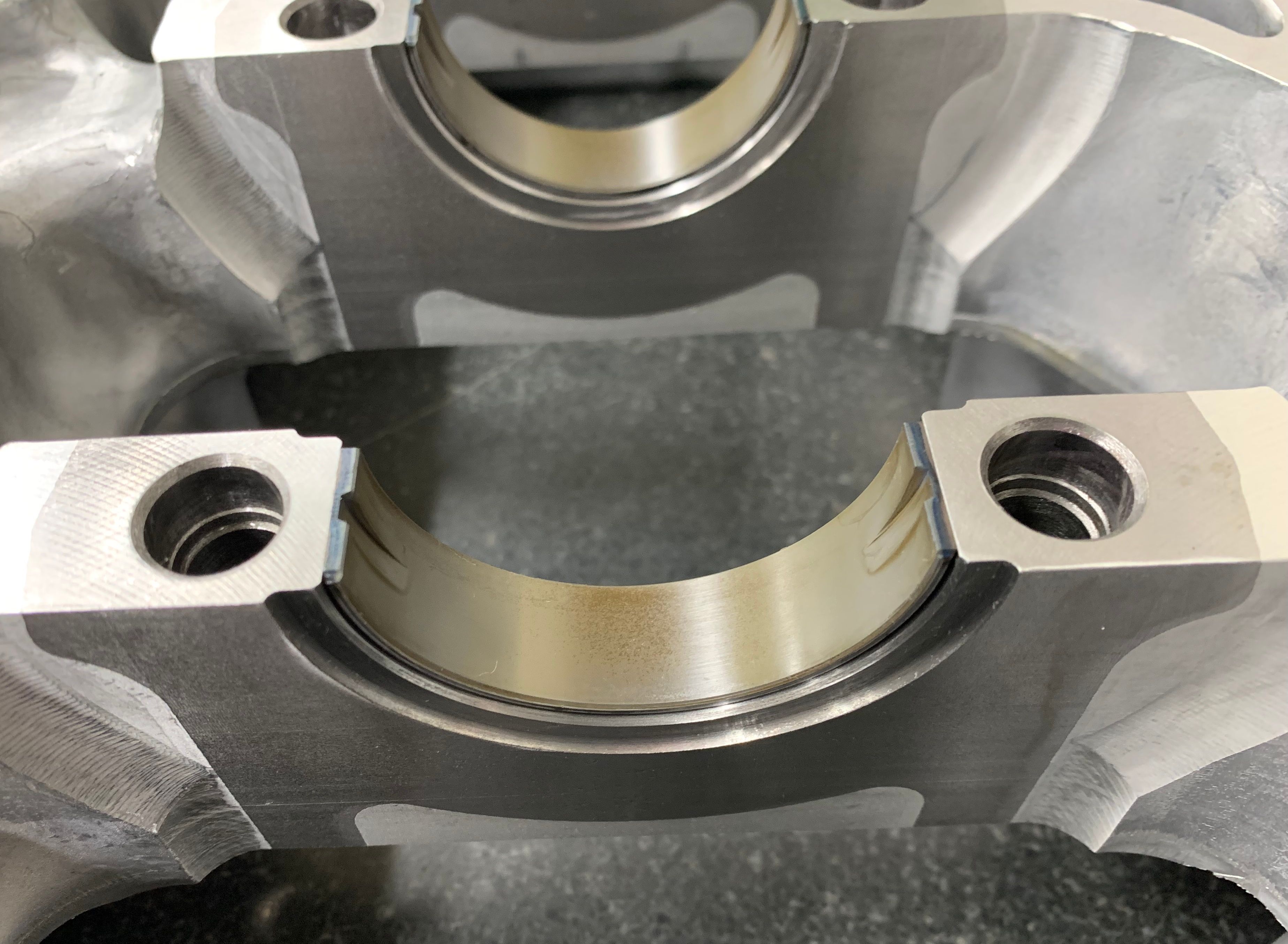 Close-up of the HKS G16E short block main bearings showing bearing surfaces designed for high load capacity.