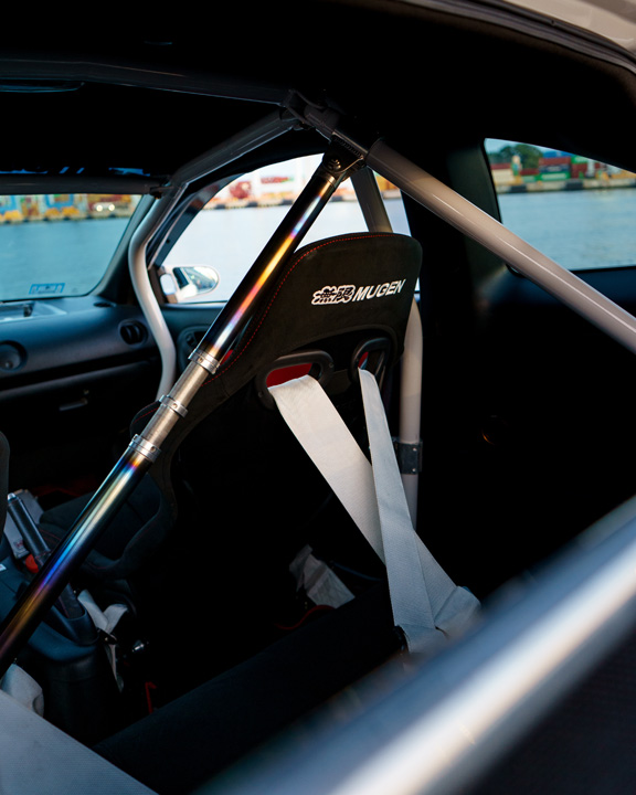 Jonathan Ortiz’s 2005 Acura RSX Type-S with Porsche PTS Fashion Grey paint, Mugen aero, J’s Racing details, blue Volk Racing CE28N wheels, turbocharged K-series engine bay, DC5R interior conversion, and Sony ES audio setup.