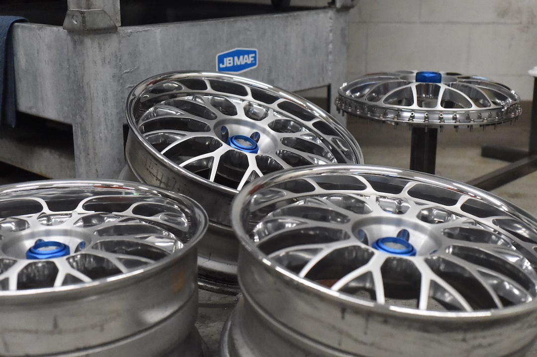 Refinished Advan Siena Gen II wheels with polished lips and detailed centers inside the JB MAF workshop.