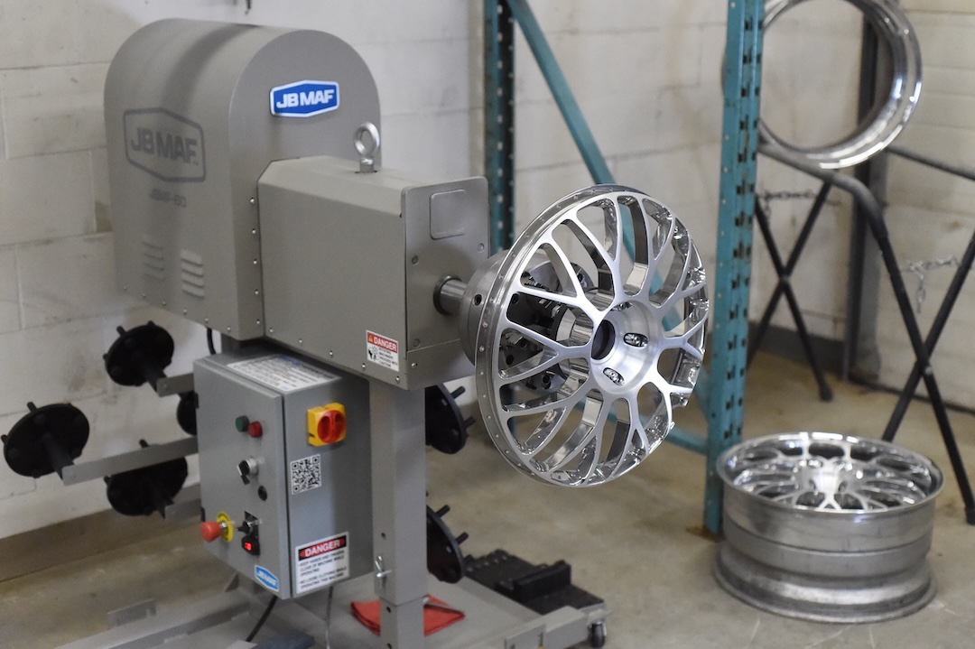 Advan Siena Gen II wheel mounted on JB MAF refinishing equipment during the refinishing process.
