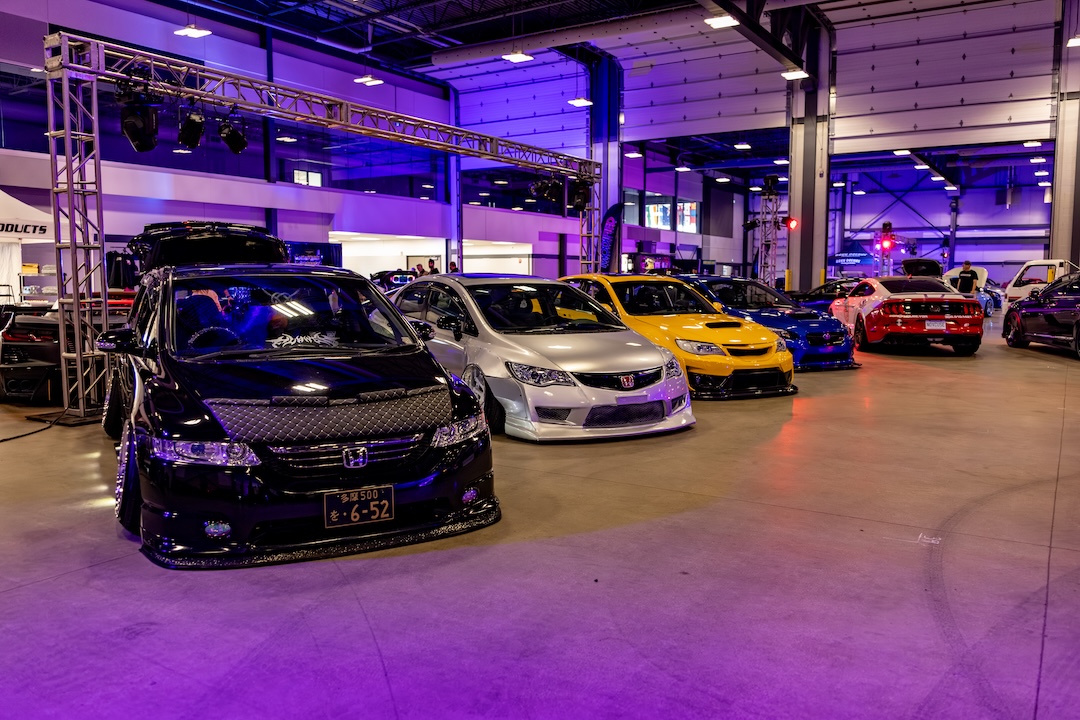 Modified cars displayed under LED lighting at the 2026 Modified Automotive Show in Regina, Saskatchewan.