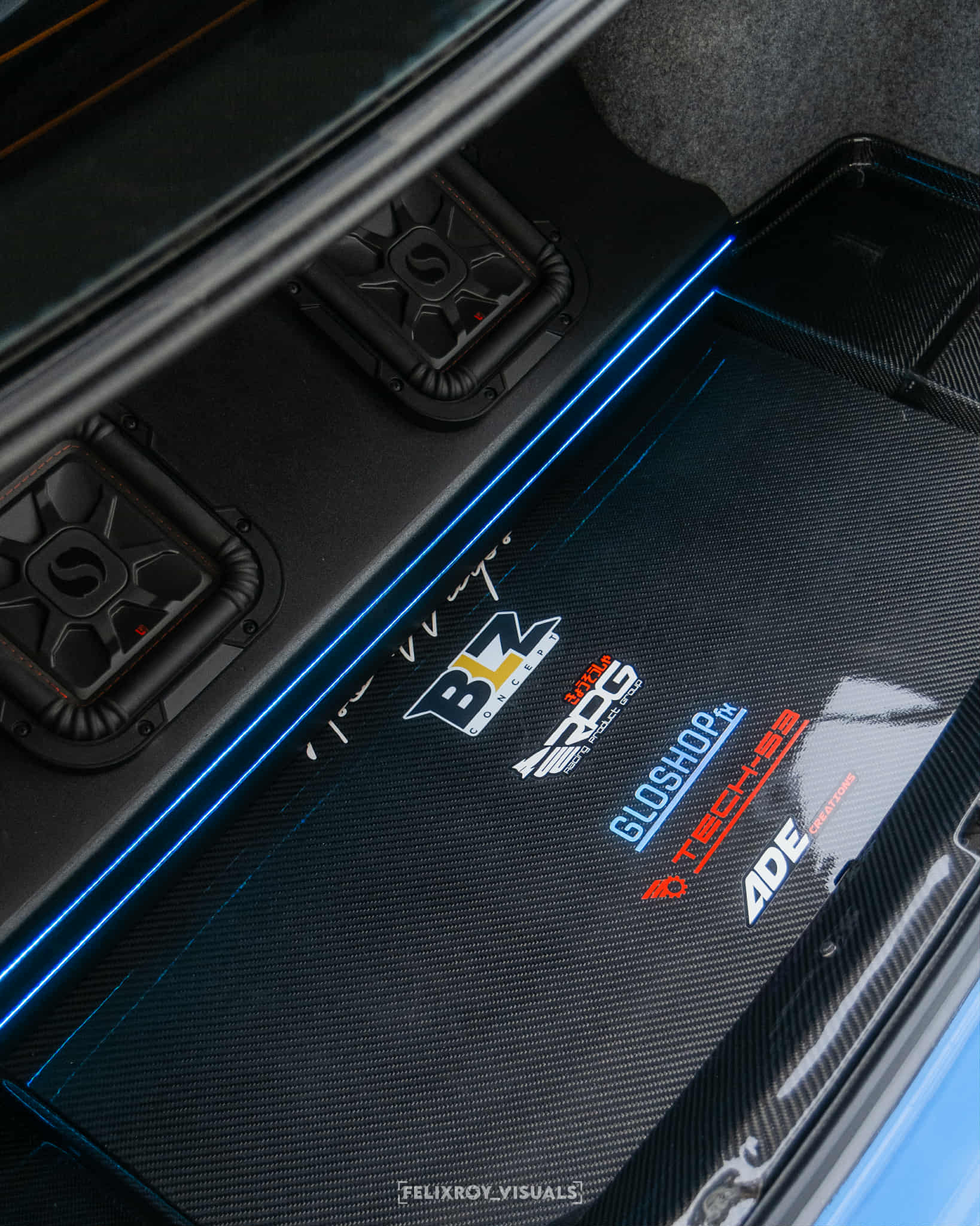 Dual Kicker subwoofers in the custom carbon fiber audio installation of Jonathan St Pierre’s 2005 BMW 330Ci.