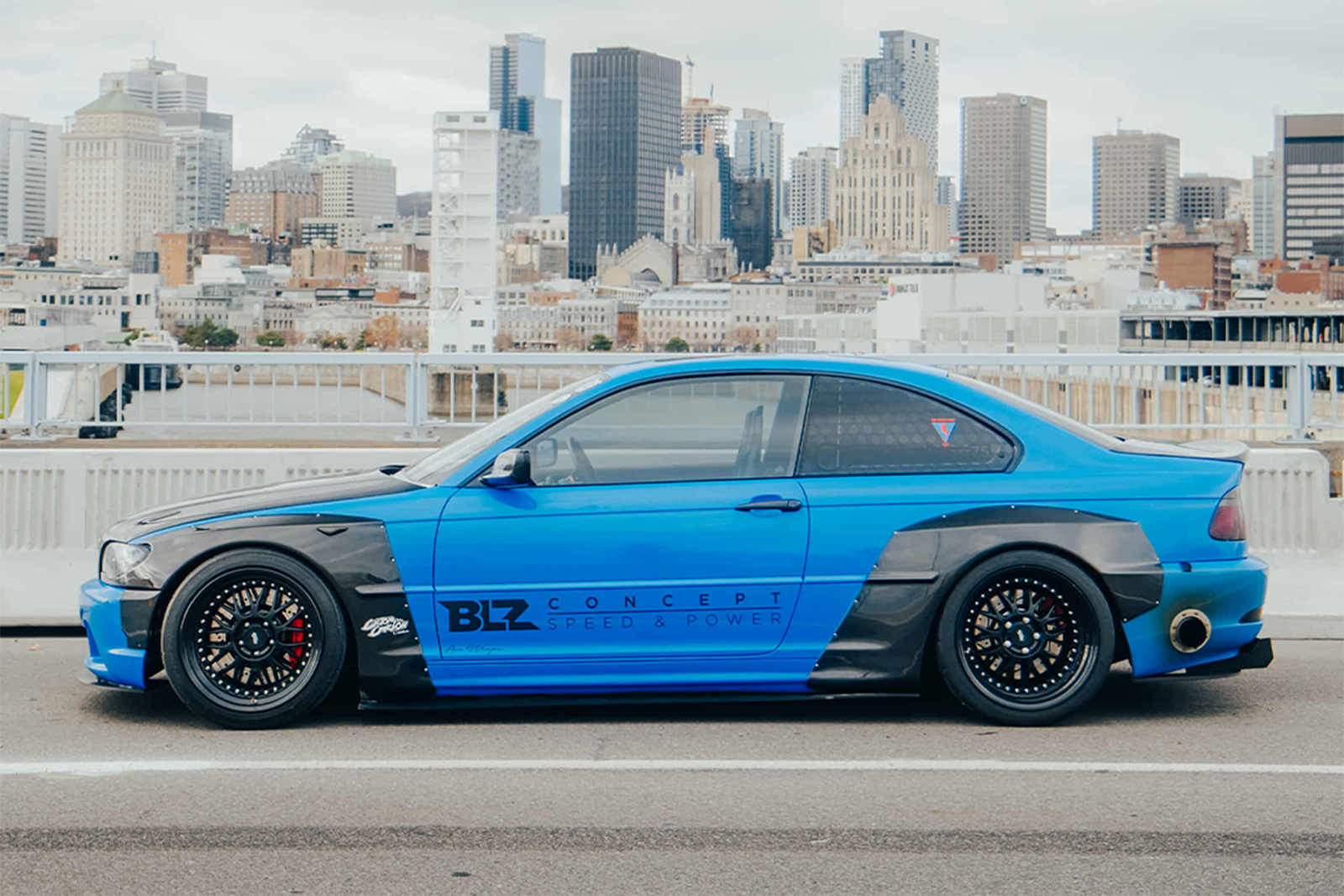 Side profile of Jonathan St Pierre’s 2005 BMW 330Ci showing its Pandem widebody kit and Work Meister M1 wheels.